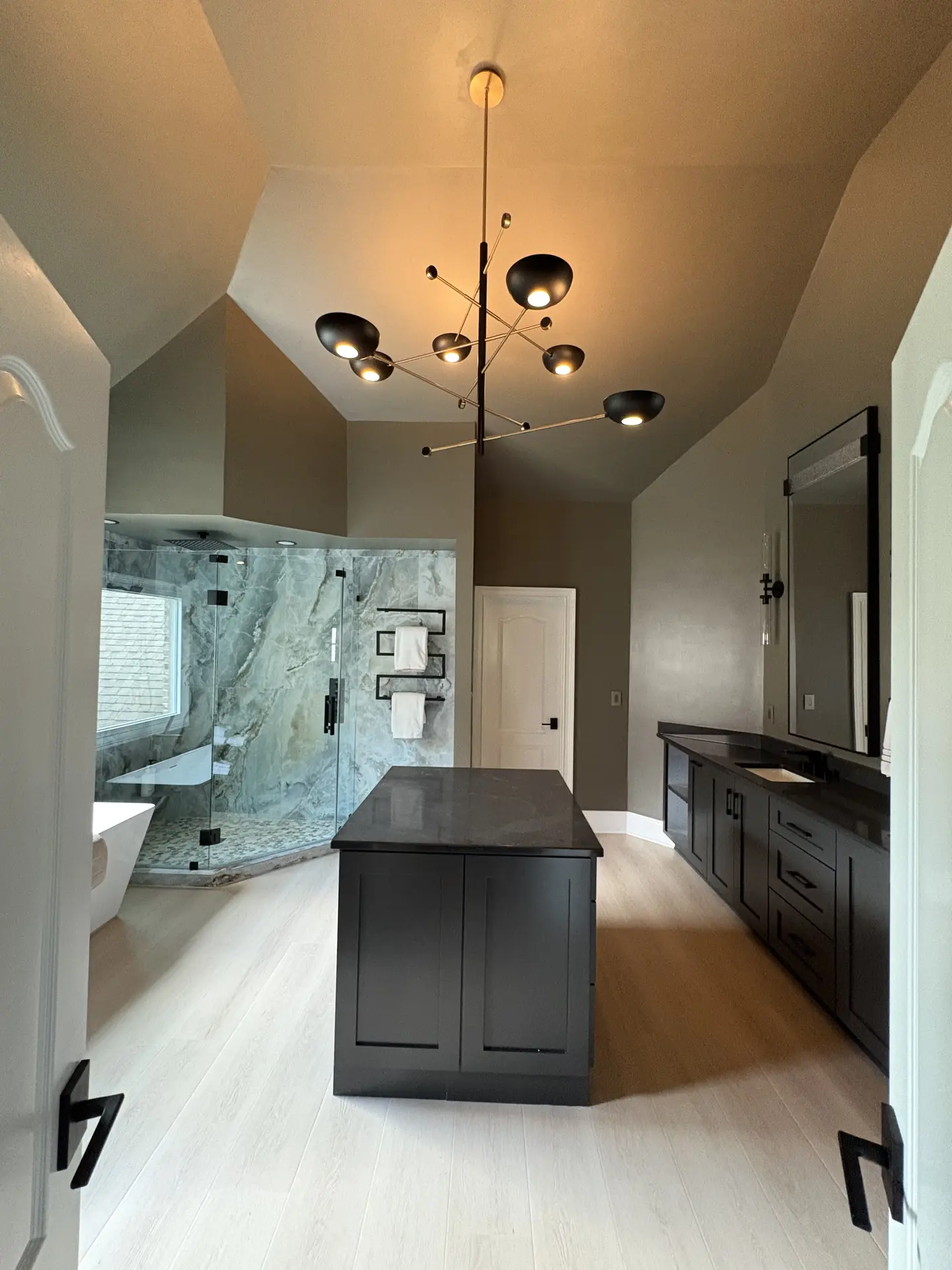 Finished bathroom remodel with chandelier